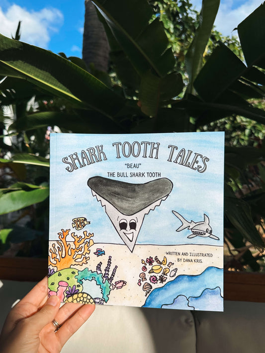 Book titled 'Shark Tooth Tales' about a shark tooth adventure.